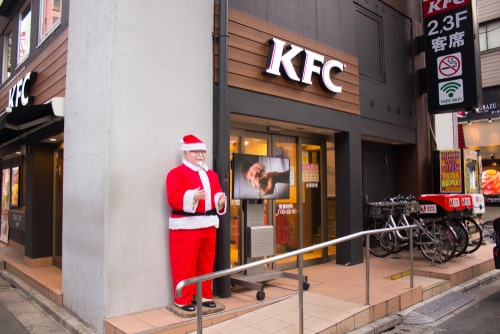 Akihabara, Japan- November 26, 2018 A statue wearing Christmas themed clothes stands in front of the KFC restaurant in Akihabara.