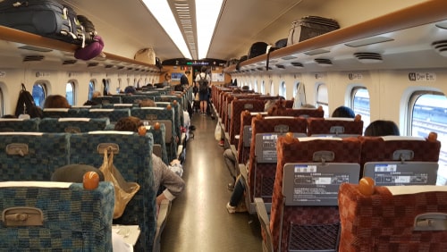 People inside coach of Sakura Shinkansen Bullet Train in Japan get down at Fukuyama station. The Shinkansen is a network of high-speed railway lines in Japan.