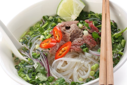 Pho bo , Vietnamese food , rice noodle soup with sliced rare beef.