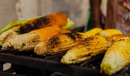 A set of roasted corns, one of the typical street foods in Guatemala, eaten with salt and lemon.