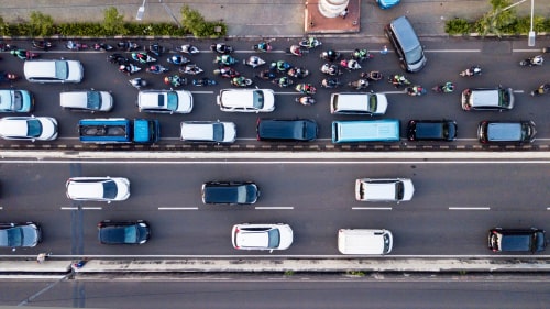 Aerial photo of Jakarta hectic traffic at peak hour with motorcycles and cars on the road.