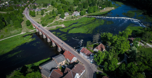 Areal view of The old brick bridge across the Venta river in Kuldiga, Latvia, the longest road bridge in Europe built in 1874 , and Venta rapid in the background.