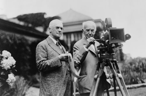 Thomas Edison and George Eastman standing with motion picture camera ca. 1925.