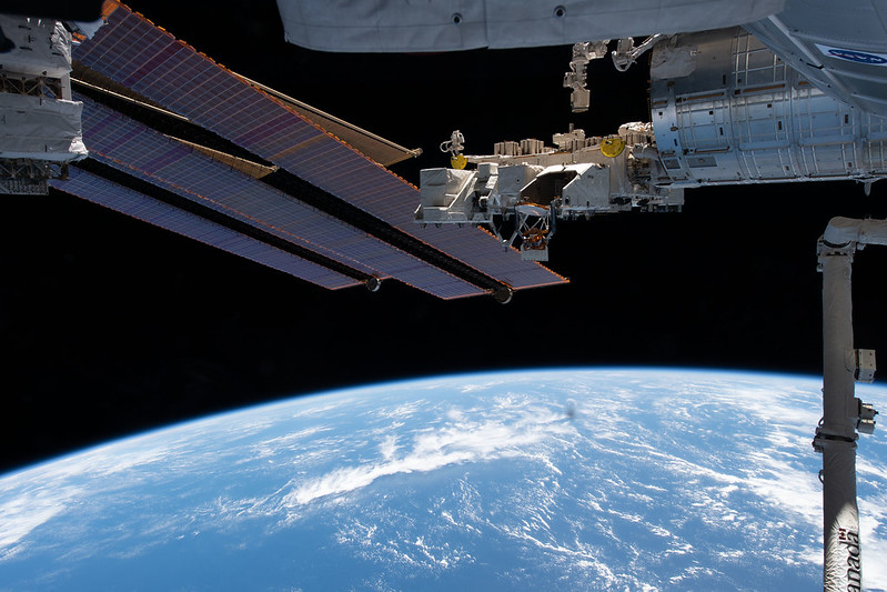 Portions of the space station pictured above the Pacific Ocean