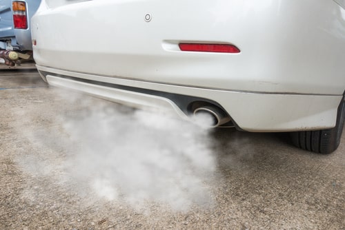 Smoke from a car exhaust pipe. car facts