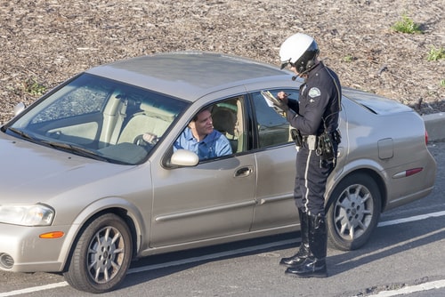 Los Angeles Police Department Police officer issuing a driver with a citation (ticket) for driving offences.. facts about cars 2020