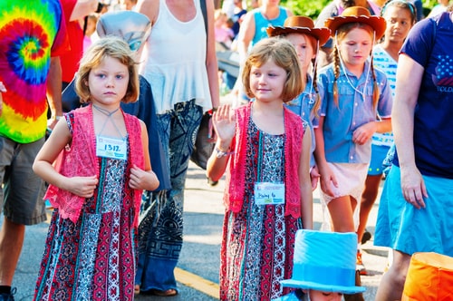 Young twins walking in the Double Take Parade, part of the 40th annual Twins Day