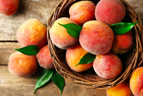Ripe peaches in basket.