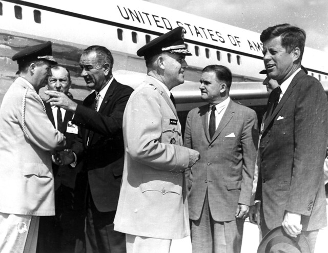 US President John F Kennedy on the tarmac with Vice President Lyndon Johnson and other senior aides.
