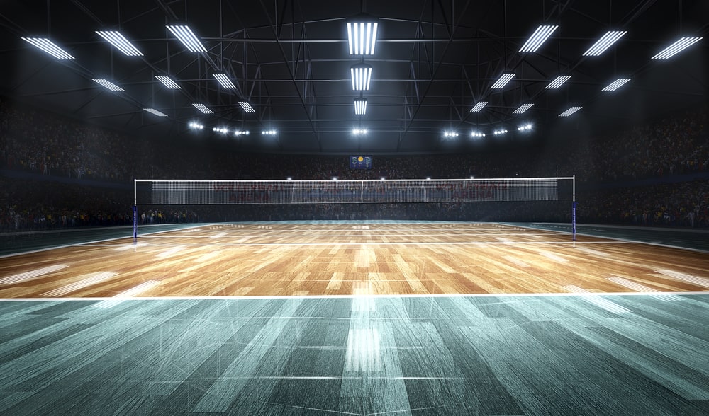 an indoor volleyball court in lights. facts about volleyball