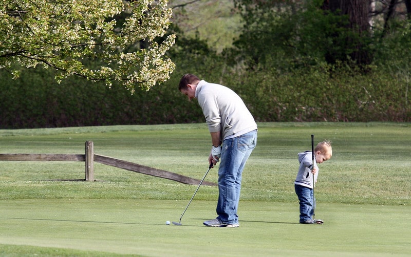 Father and son playing golf. Interesting facts about golf.