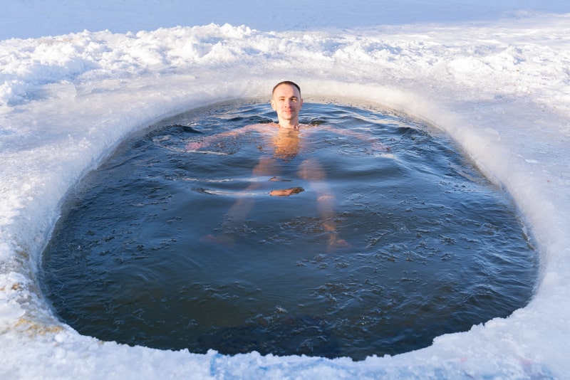 A man swimming in a cold hole in ice water. 5 facts about swimming