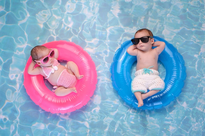 Baby Twin Boy and Girl Floating on Swim Rings. facts about Swimming