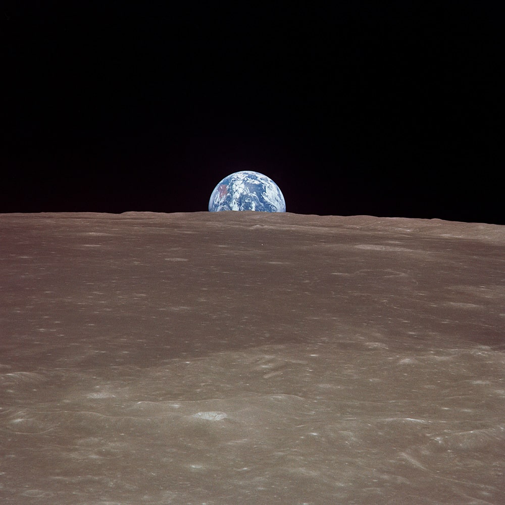 The Earth rising over the limb of the Moon.