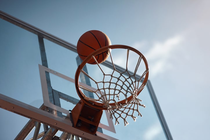 Closeup shot of a basketball landing into a net 