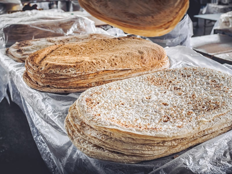 stacks of lavash bread selling on farmers market at Armenia