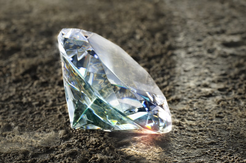 Sparkling Diamond resting on a rich earth texture. Arkansas fact file