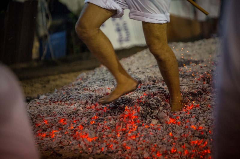 an individual during fire walking in a festival. 