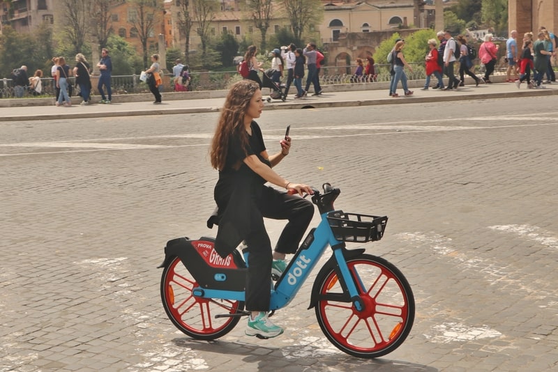 A girl riding e-bike in Rome.